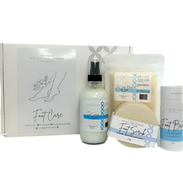 A natural canadian made old soul soap company foot care collection featuring a salt soak, peppermint foot scrub, foot balm and foot spray in a white gift box shown on white background
