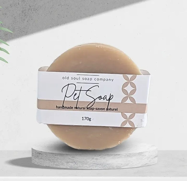 This round labelled Canadian made natural pet soap from the Old Soul Soap Company is standing on its side on a white background. It features neem oil to help repel fleas and ticks.