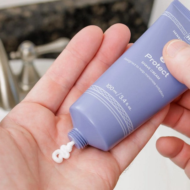 Henson Protect Shave Cream being squeezed from travel-size tube into hand