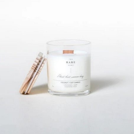 This 'About that summer day' coconut and soy candle scented with lavender and sage essential oils is made in Canada by The Bare Home and features a wooden wick and a wooden lid. It is pictured on a white background with the lid off.