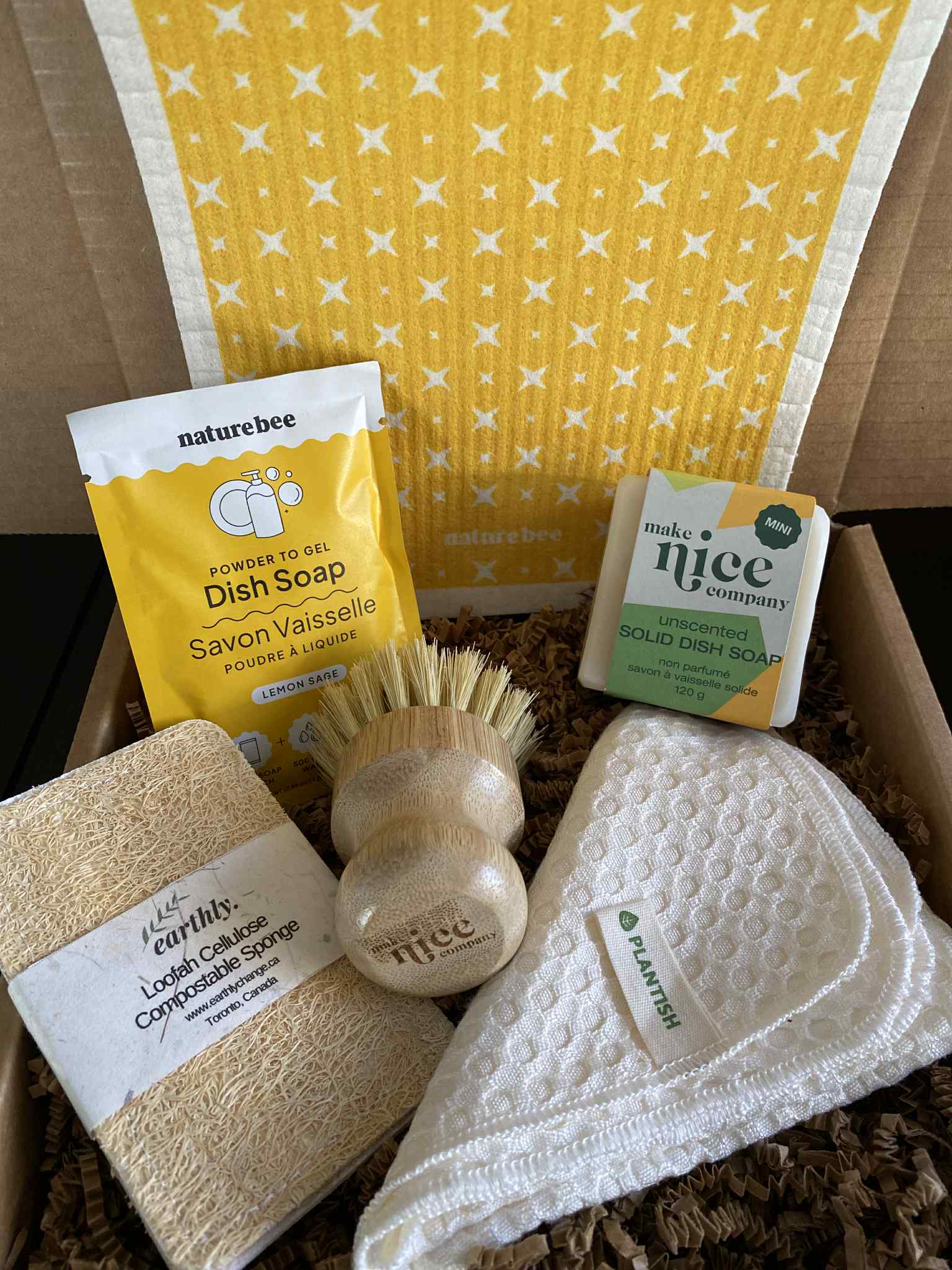 Zero-waste Lemon Sage Kitchen Gift Box featuring Canadian-made eco-friendly cleaning essentials, including Nature Bee lemon sage dish soap, Make Nice solid dish soap bar, bamboo pot scrubber, cellulose loofah sponge, Swedish dishcloth, and Plantish bamboo cloth — sustainable gift set for an eco-conscious home.