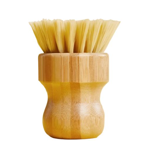 Biodegradable pot scrubber brush from the Make Nice Company on white background. The bristles of the brush are made of tampico from the agave plant and the base is made of beechwood.