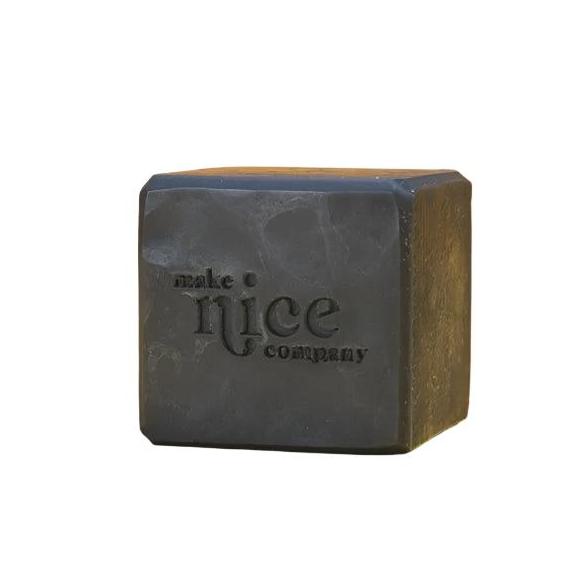 An unlabelled black unscented solid dish soap cube 240 g made in Canada by the Make Nice Company with activated charcoal on a white background