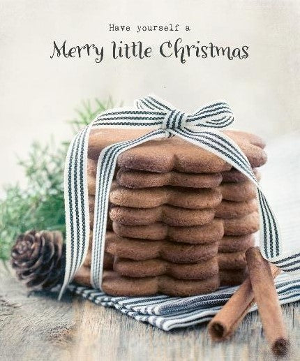 This sweet cheerful Swedish sponge cloth by More Joy features a stack of holiday spice cookies tied with a blue and white ribbon on a blue and white napkin with a pine cone, cinnamon sticks and greenery in the background. It features the message, "Have yourself a Merry little Christmas."