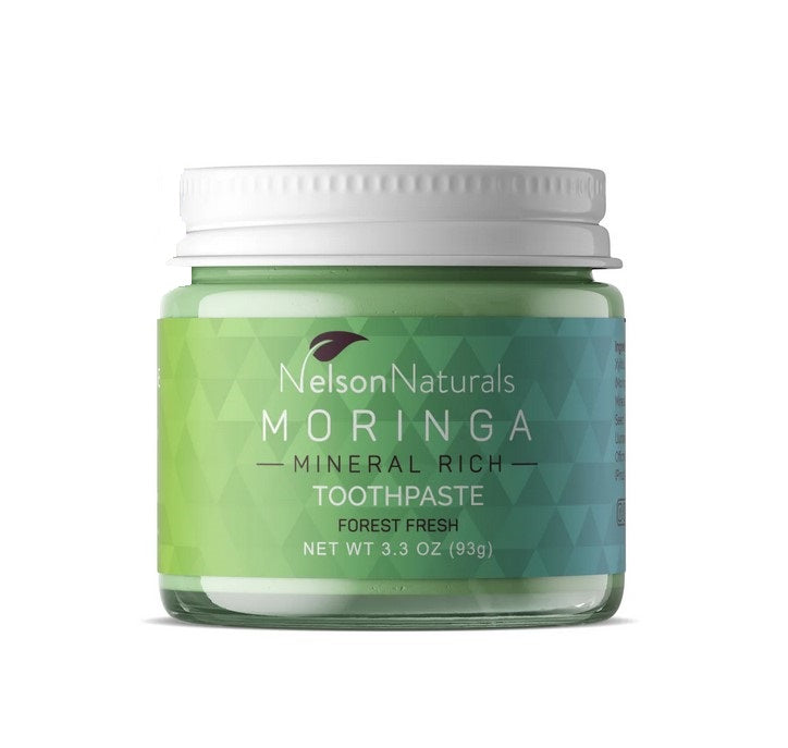 Canadian made mineral rich Moringa toothpaste in a forest fresh flavor by Nelson Naturals in a clear 93 g/3.3 oz glass jar with white lid. Shown pictured on a white background.