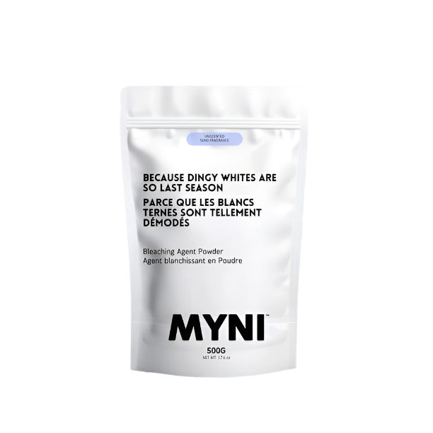 A white resealable, compostable stand-up pouch of 500 g of bleaching agent powder made in Canada by myni is pictured on a white background. The bag says in black type, "Because dingy whites are so last season." 