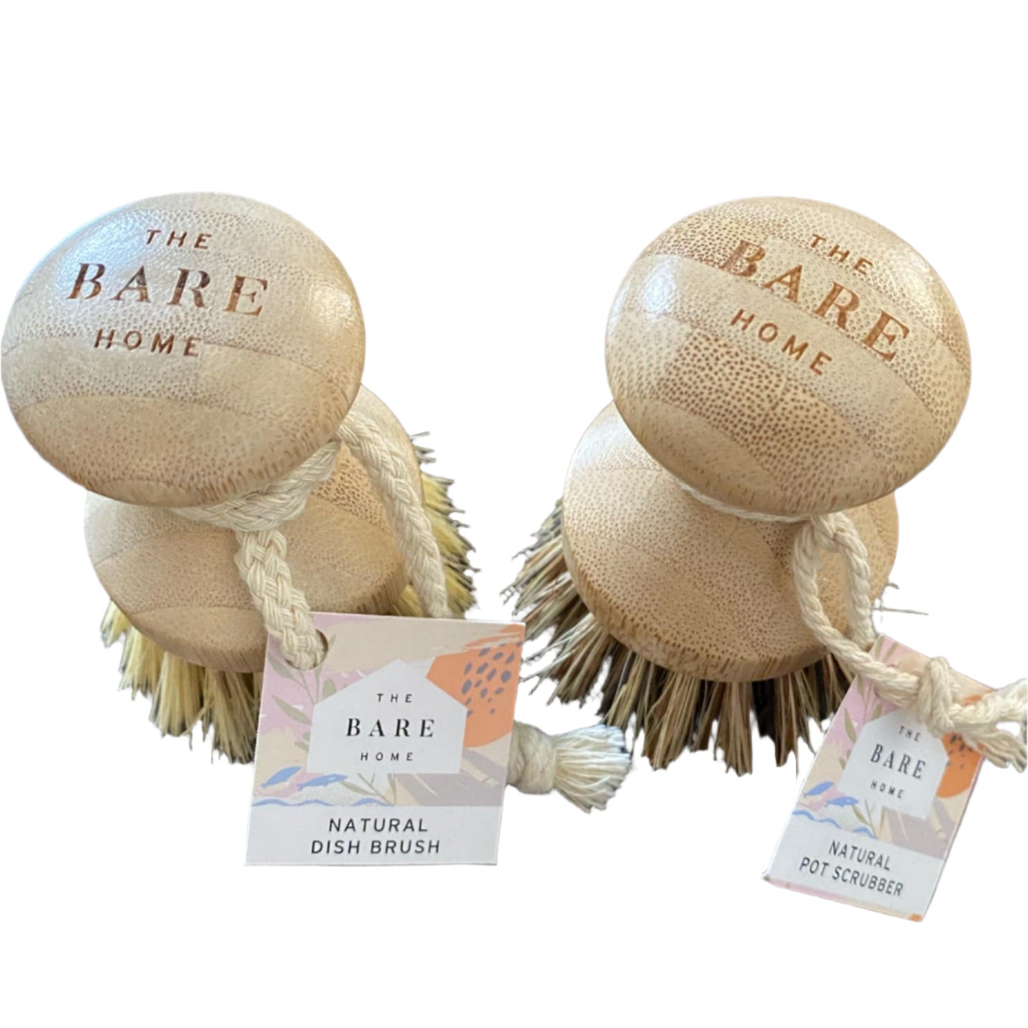 Two wooden dish brushes with bristles and tags labeled 'The Bare Home' on a white surface.