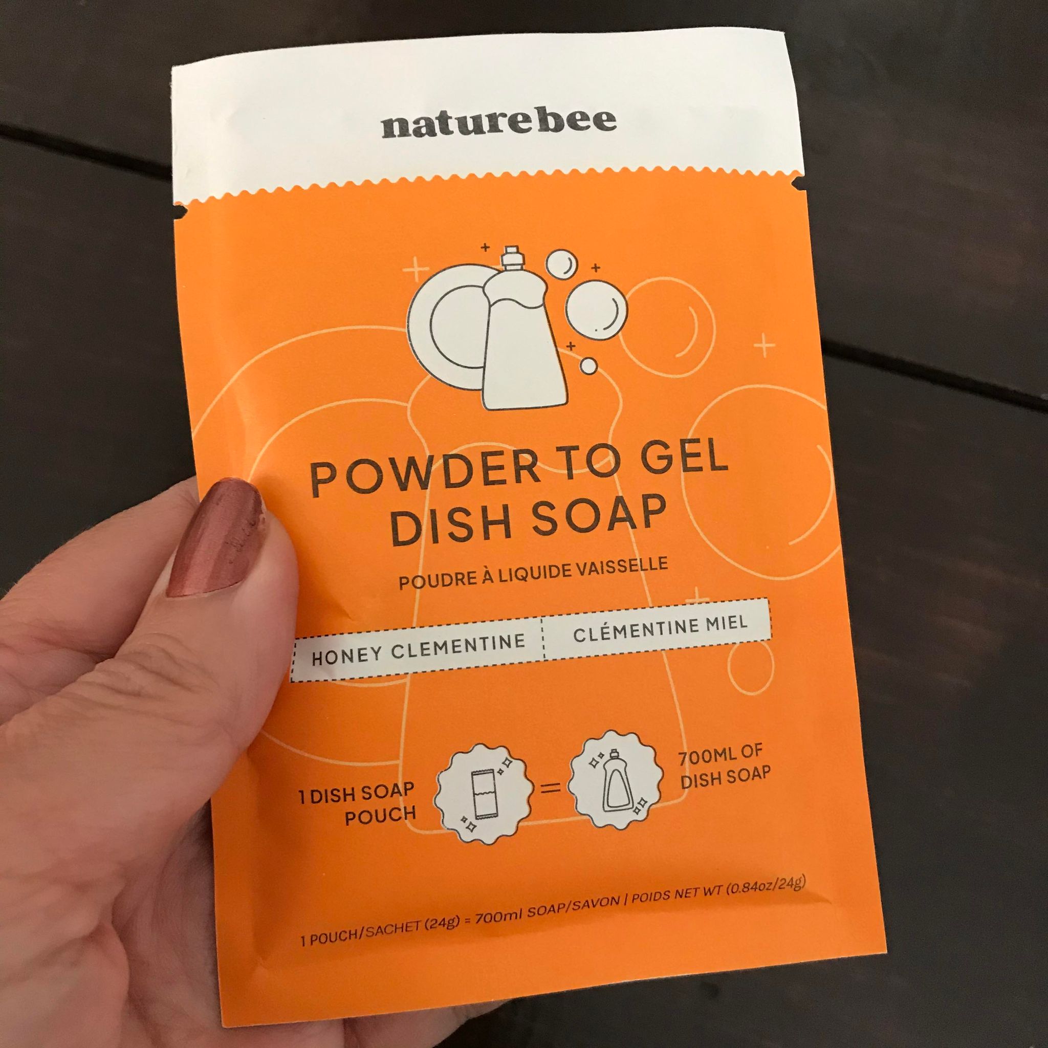 One bag compostable pouch of honey clementine scented powdered dish soap from Nature Bee makes 700 ml of gel dish soap when you add water.