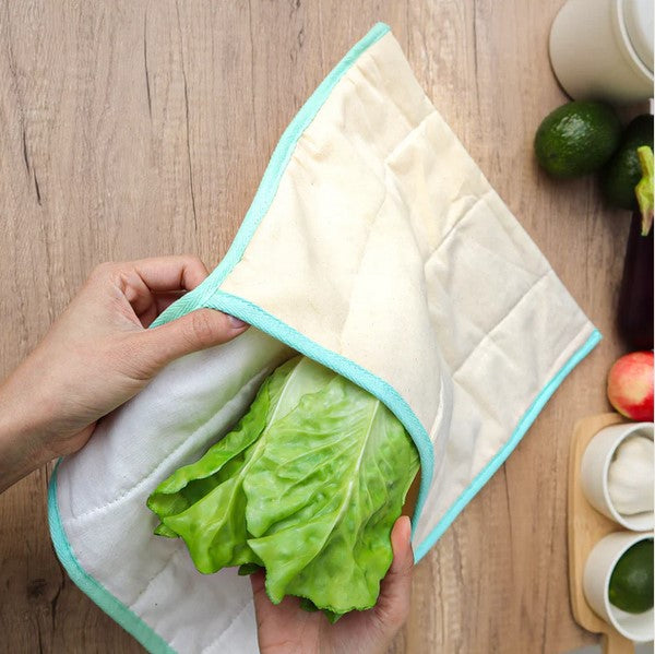 This Produce Saver Bag by Plantish is 42 cm x 52 cm (with flap open) and is made from all-natural, unseeded, and unbleached cotton designed to pull away excess moisture while keeping produce hydrated and free from toxic chemicals. This eco-friendly solution helps extend the freshness of your fruits and veggies for up to 14 extra days and is pictured with a head of romaine lettuce coming out of it.