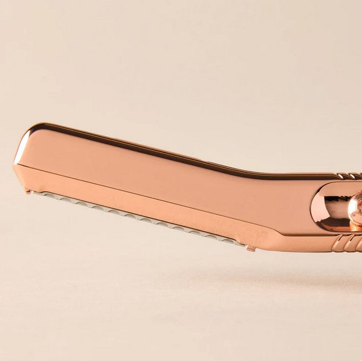 Close-up of Leaf Rose Gold Dermaplaner – plastic-free facial exfoliating tool with precision blade