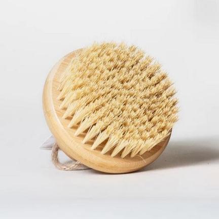 Round bamboo body brush with sisal bristles shown on a white background