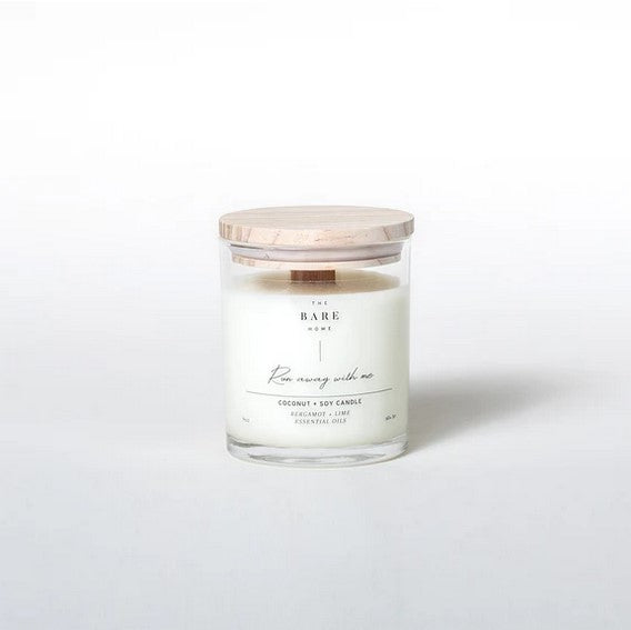 This bergamot lime 'Run away with me' coconut and soy candle by The Bare Home with a wooden wick and a wooden lid is pictured on a white background.