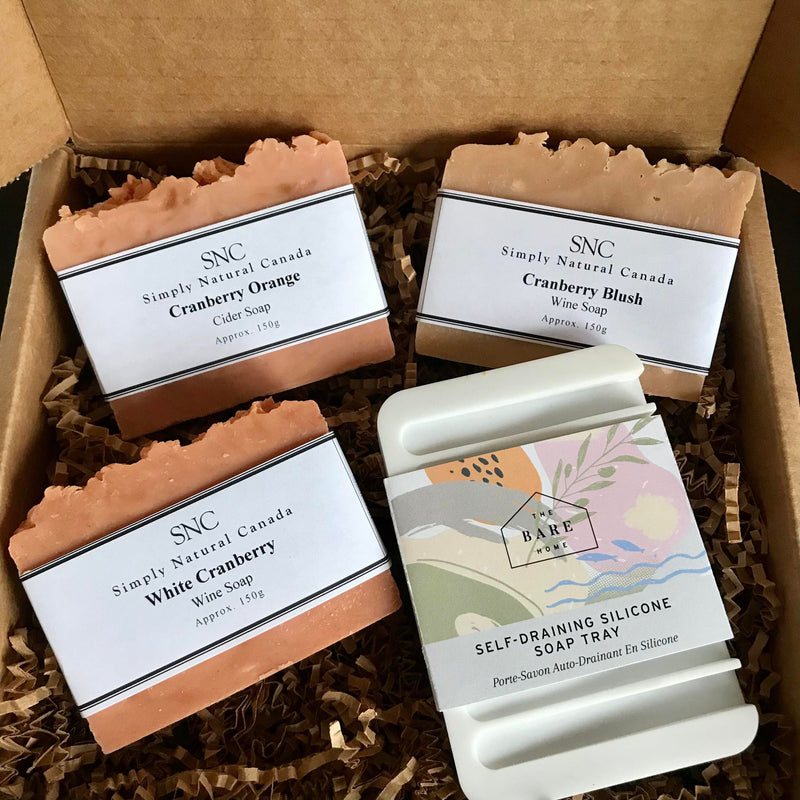 Looking for a unique seasonal gift? This SNC Cranberry Gift Box features three of our most popular seasonal soaps - White Cranberry Wine Soap, Cranberry Orange Cider Soap,  Cranberry Blush Wine Soap and self-draining silicone soap tray from The Bare Home. It all comes packed in a gift box.