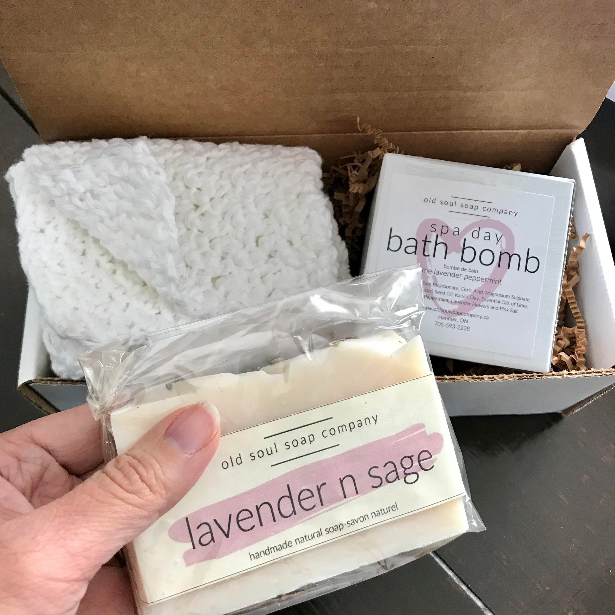 This spa day gift box features three Canadian made products - white crocheted spa cloth, a handcrafted lavender n sage vegan soap and a spa day bath bomb from the Old Soul Soap Company
