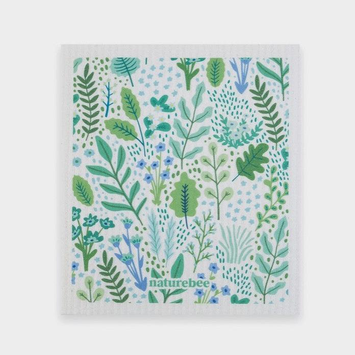 Swedish dishcloth in a pretty floral green pattern on white background by Nature Bee replaces 17 paper towel rolls and absorbs up to 20x its weight in liquid