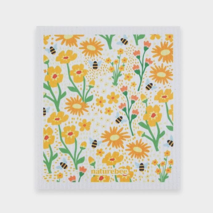 Swedish dishcloth in a pretty floral yellow pattern with bees on white background by Nature Bee replaces 17 paper towel rolls and absorbs up to 20x its weight in liquid