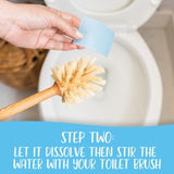 Step two, let the toilet bowl cleaning strip dissolve and then stir the water with your toilet brush