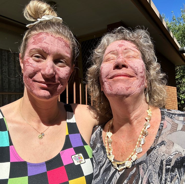 Nourishing Rose Clay Face Masks on the faces of two ladies pictured outdoors. This  Canadian made Birch Babe product comes in a 45 g glass jar and improves skin's elasticity, boosts hydration, and softens dark spots. 