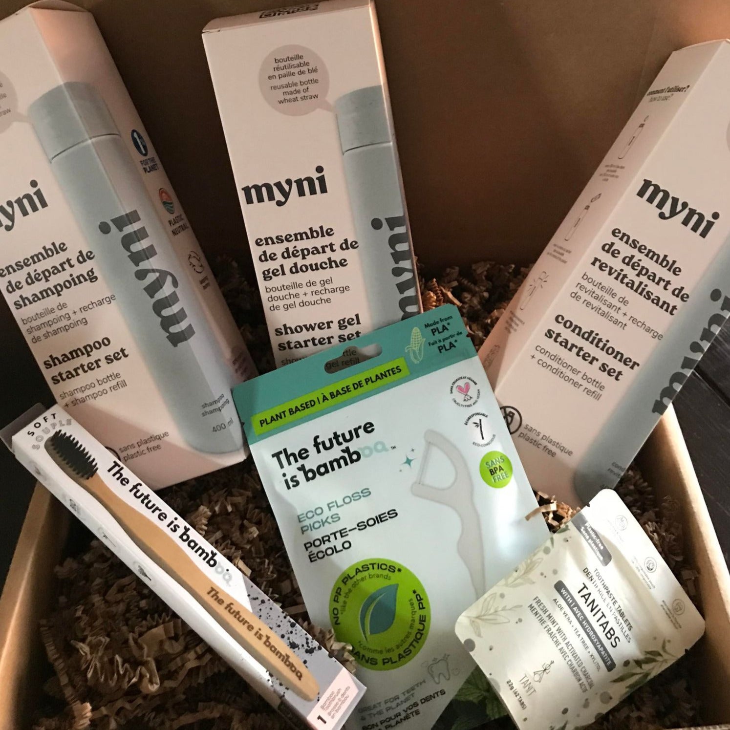 This personal care gift set includes a three myni starter kits - a shower gel, shampoo and conditioner (refillable biodegradable wheat straw bottle and powder to liquid pouch in each) as well as a one month supply of fresh mint with activated charcoal toothpaste tablets. 50 compostable floss picks, and a bamboo toothbrush with charcoal bristles