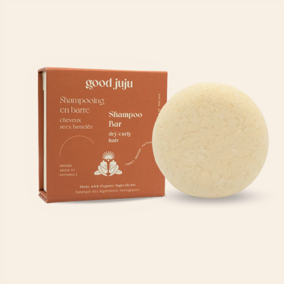 Orange and patchouli scented shampoo bar for dry curly hair in a zero waste box made in Canada by good juju