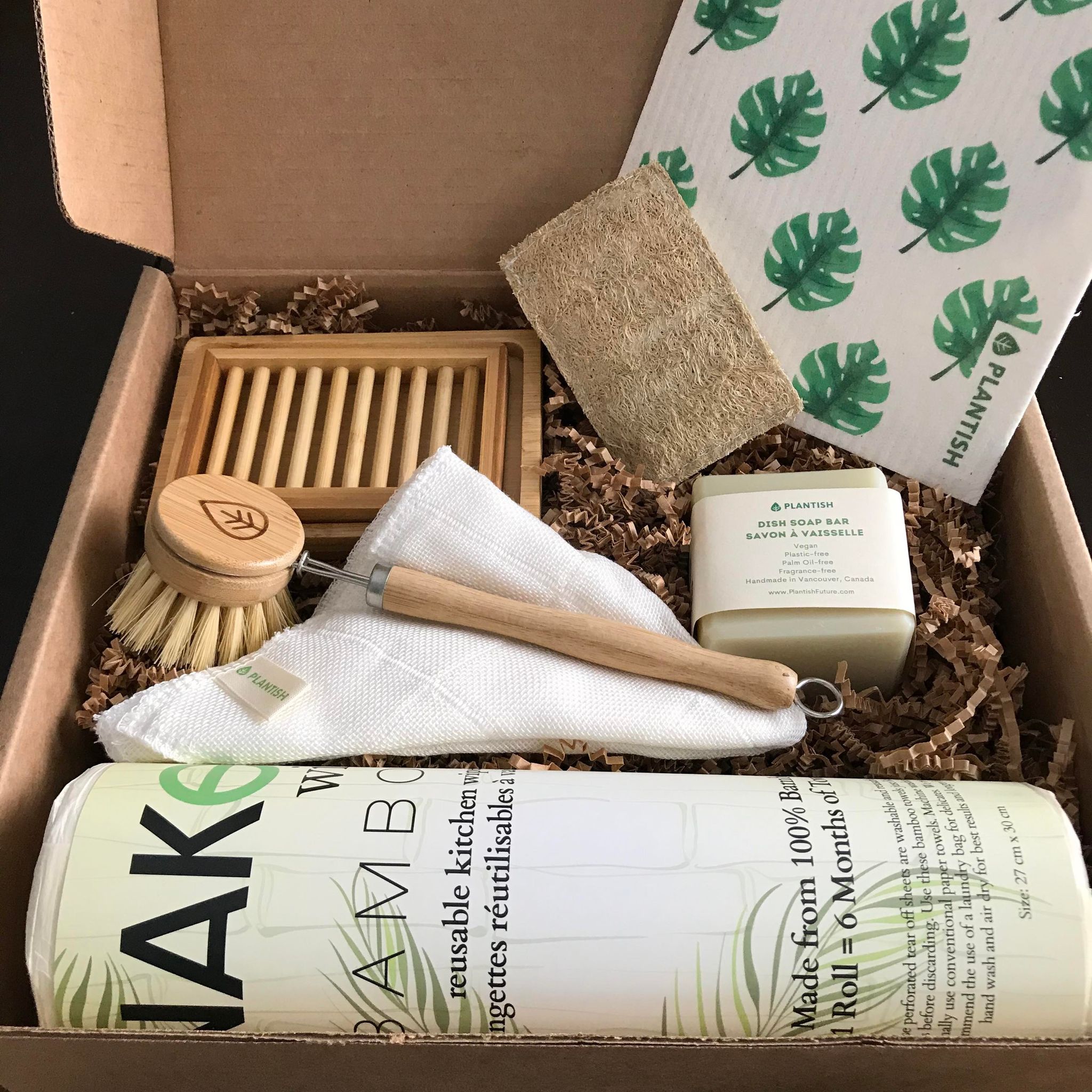 Each zero waste kitchen gift set includes a dual layer bamboo soap dish, eco sponge, Swedish dish cloth, sisal dish brush, bamboo cloth, dish soap bar and a roll of bamboo NakedWipes.