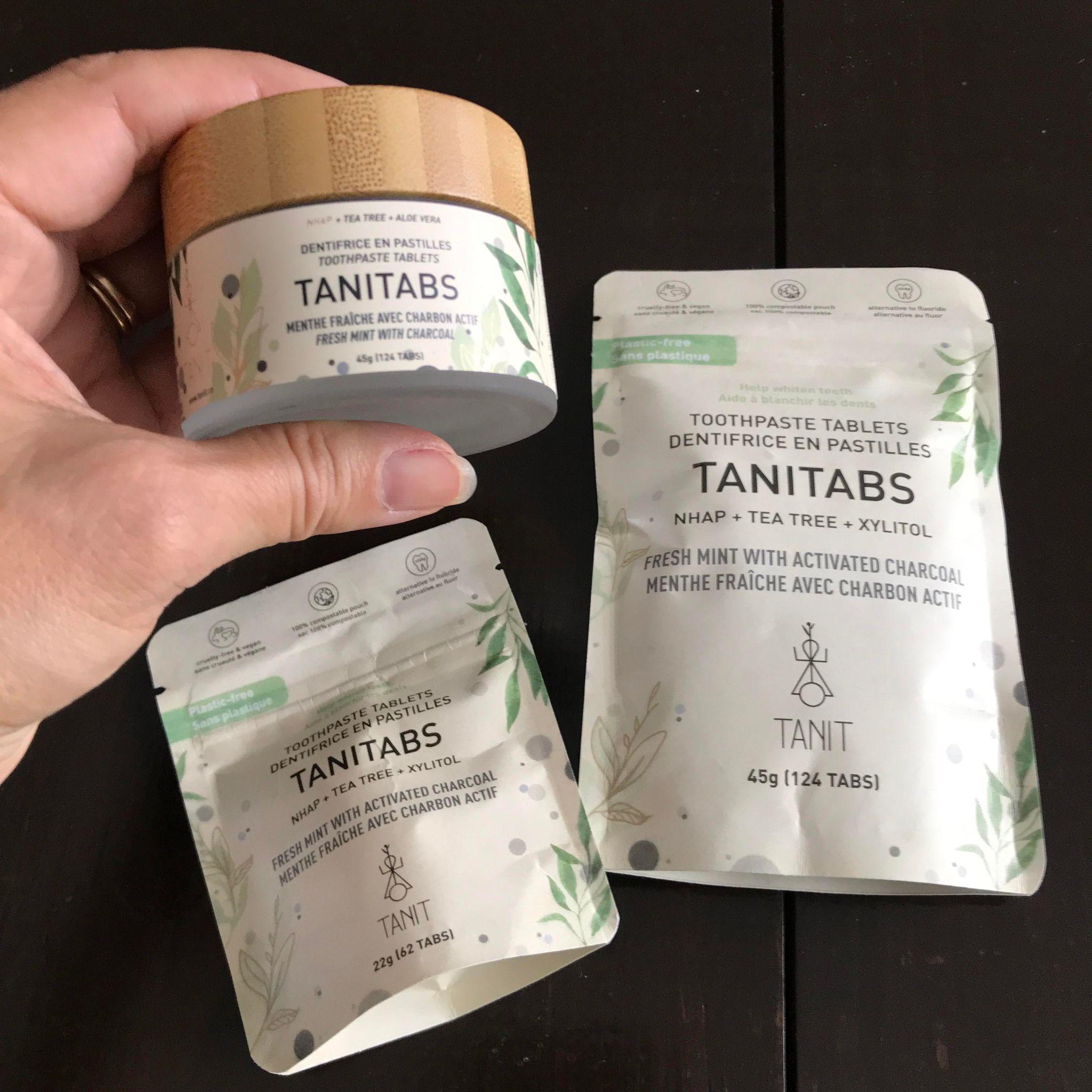 Fresh mint activated charcoal toothpaste tablets available in a 45 g glass jar (124 tablets)  as well as compostable pouches of either 62 or 124 tablets made in Canada by Tanit
