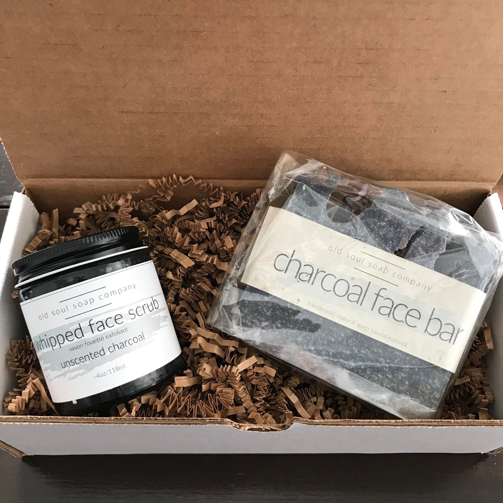 natural facial care kit made in canada by the old soul soap company features a unscented charcoal whipped face scrub in a 4 oz glass jar and a charcoal face bar in a gift box 