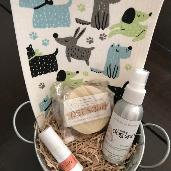 This dog themed gift basket includes a dog themed Swedish cloth from David Shaw Designs, a paw balm,  a pet soap with neem oil and a stinky dog spray in a metal basket with handles,