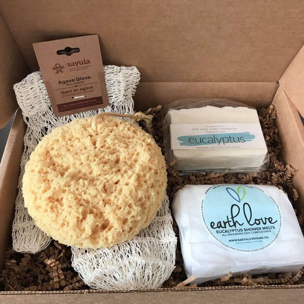 sustainable home spa gift set with a sayula agave glove for gently exfoliating your skin, a foam sea sponge, a eucalyptus mint artisan vegan old soul company soap and a six pack of earth love eucalyptus shower melts in a brown cardboard gift box