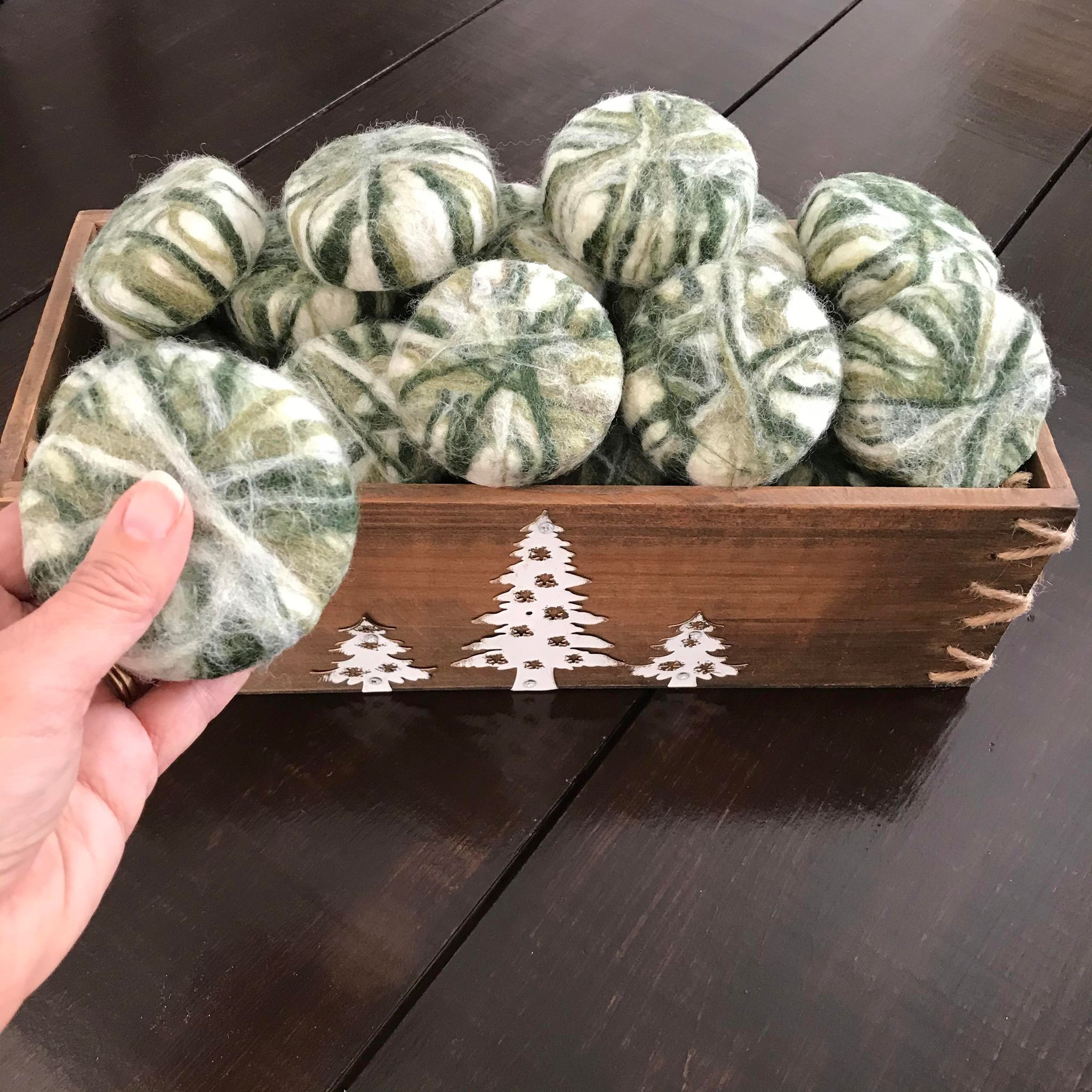 Wooden crate  full of canadian made cedar sage essential oil simply natural canada round soaps hand felted in winter green shades using 100 per cent wool 