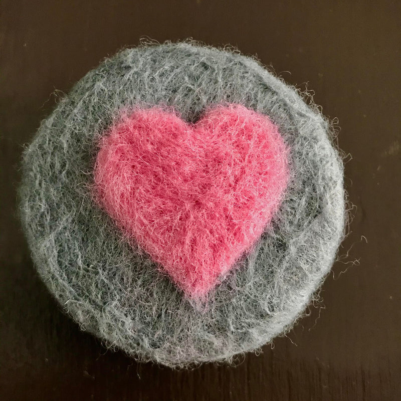 rosemary mint natural round essential oil  soap hand felted with a pink heart on grey background made in canada by simply natural canada 