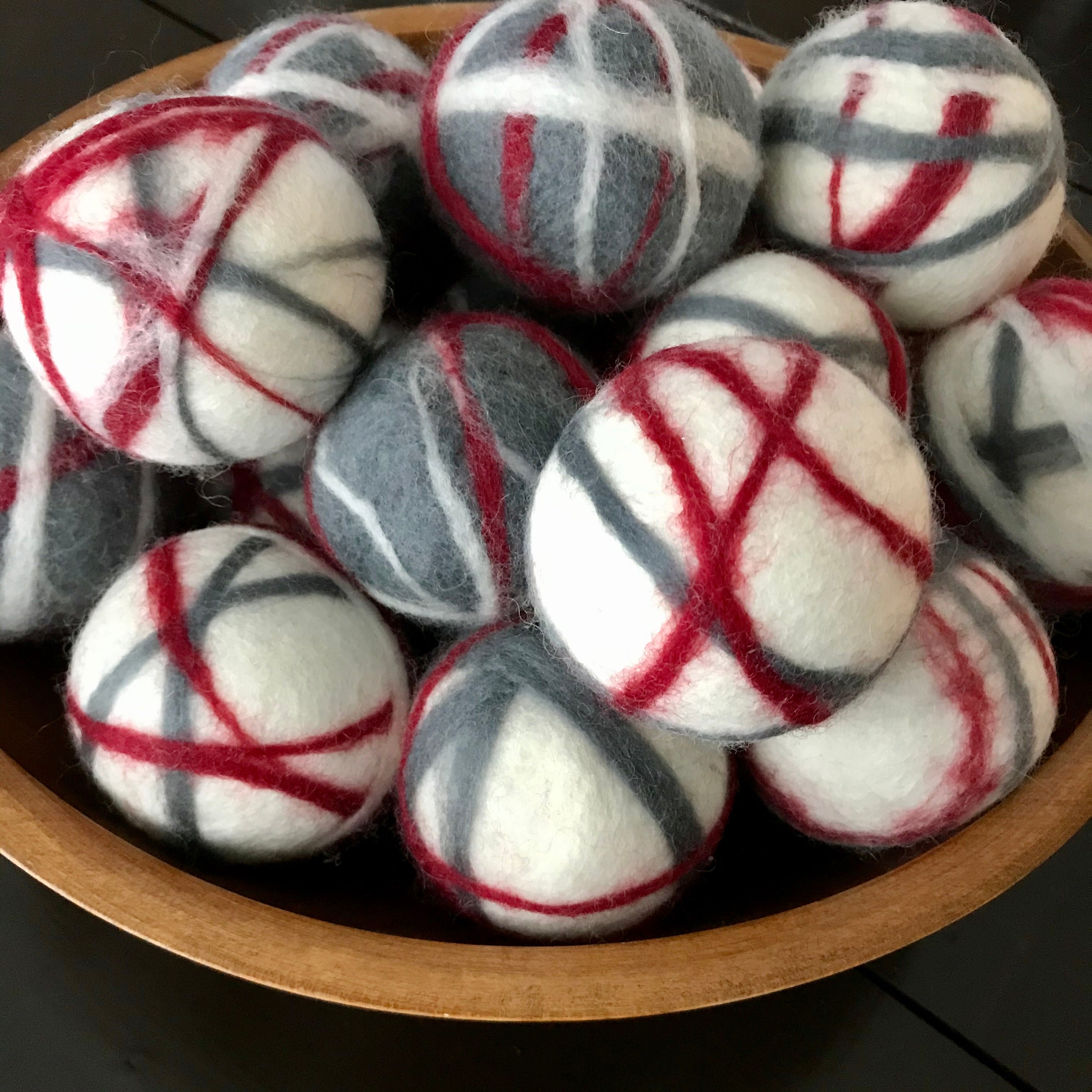 large canadian made red, white and grey 100 percent wool dryer balls sold individually or in a set of 3 in a cloth bag