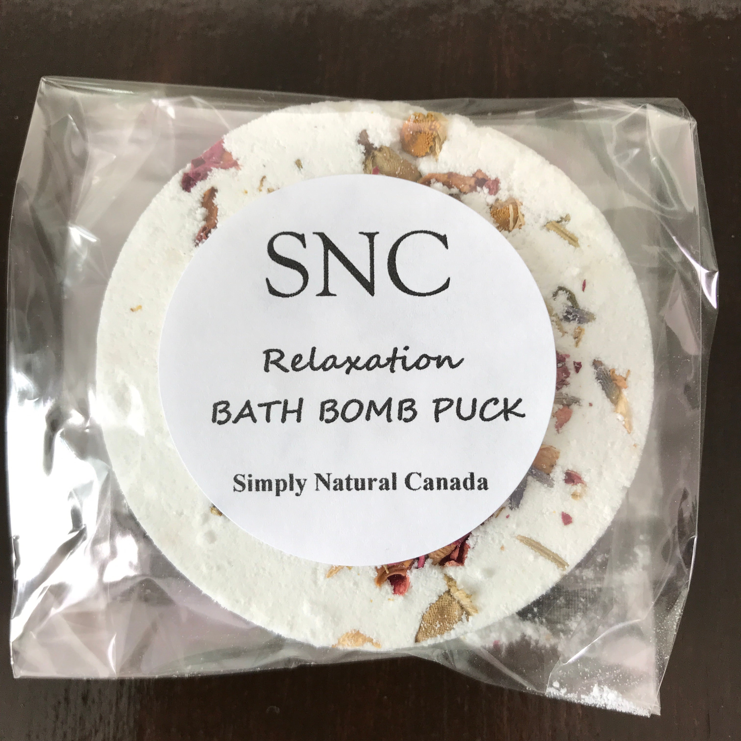 canadian made floral essential oil blend bath bomb puck in clear compostable wrap for relaxation