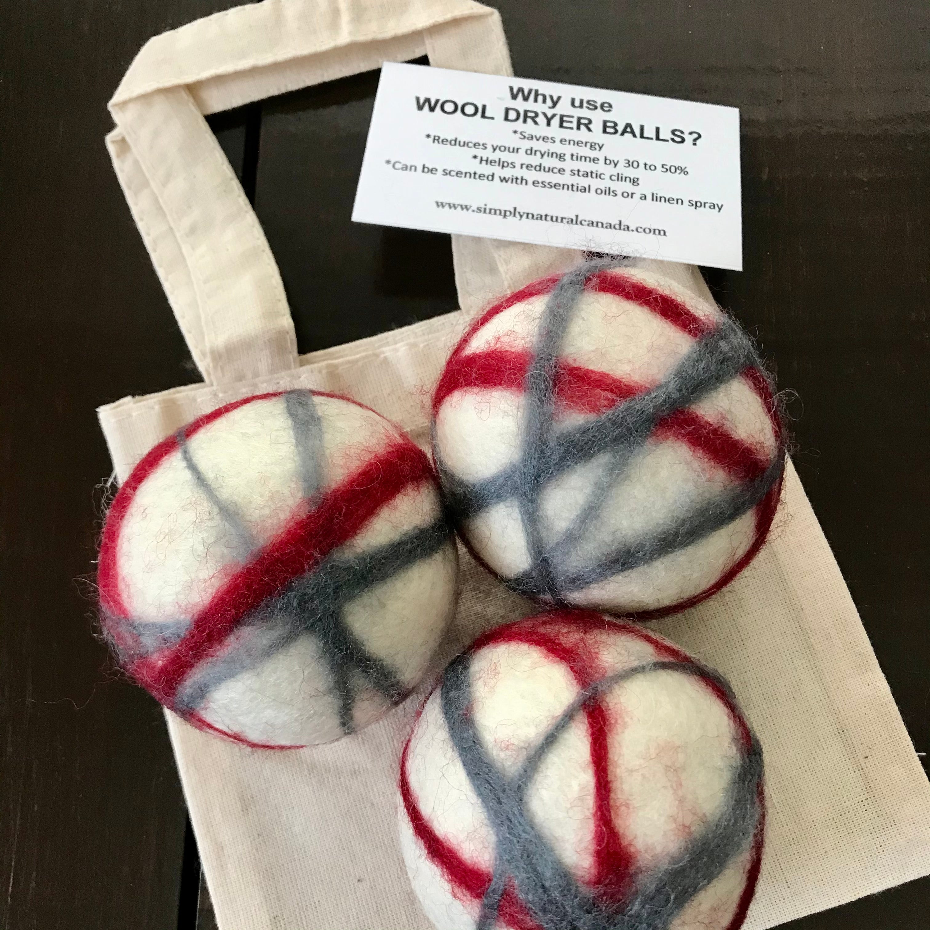 set of 3 canadian made white, red and grey 100 percent wool dryer balls sold in a cloth bag