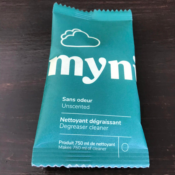 An individual unscented degreaser cleaner tablet in compostable pouch made in Canada by myni makes up to 750 ml of cleaner just by adding water and a tablet to a spray bottle