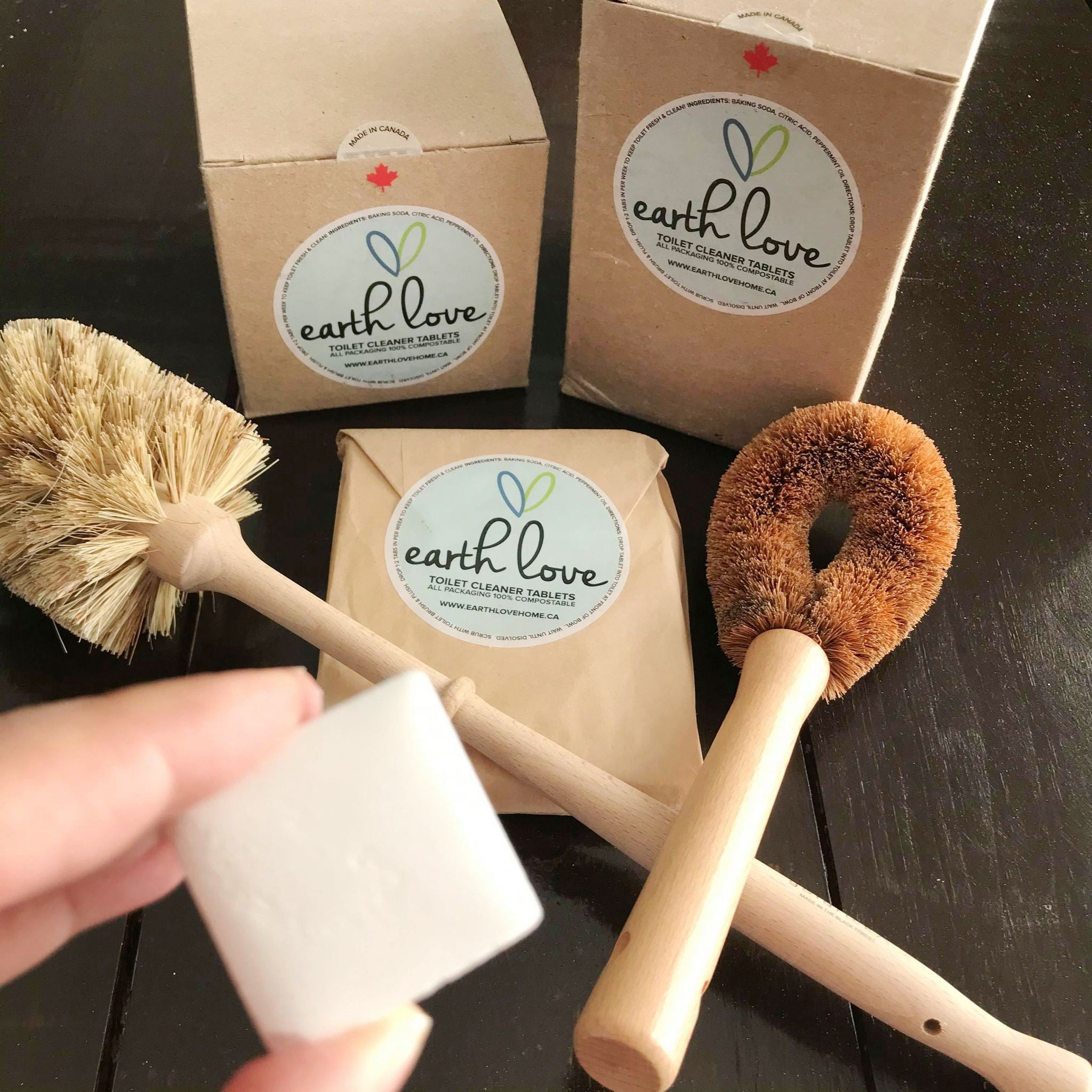 natural toilet cleaning tablets made in canada by earth love and two sustainable brush options for cleaning the inside rim of a toilet bowl