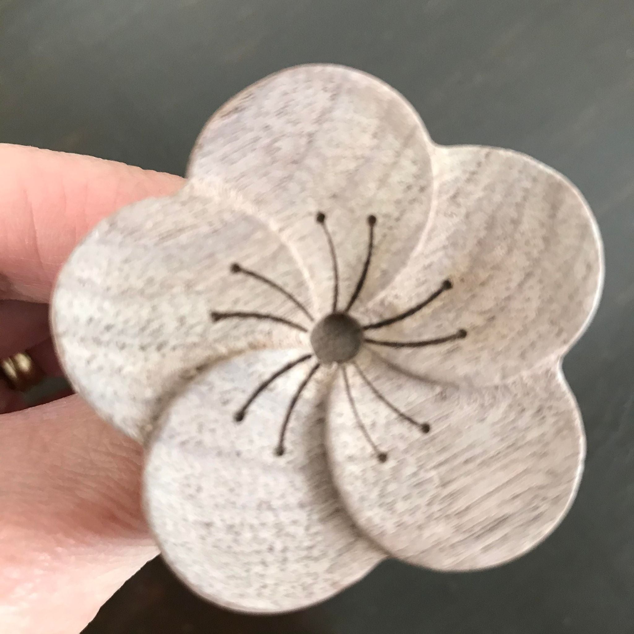 pocket sized wooden essential oil diffuser in a flower shape is travel friendly