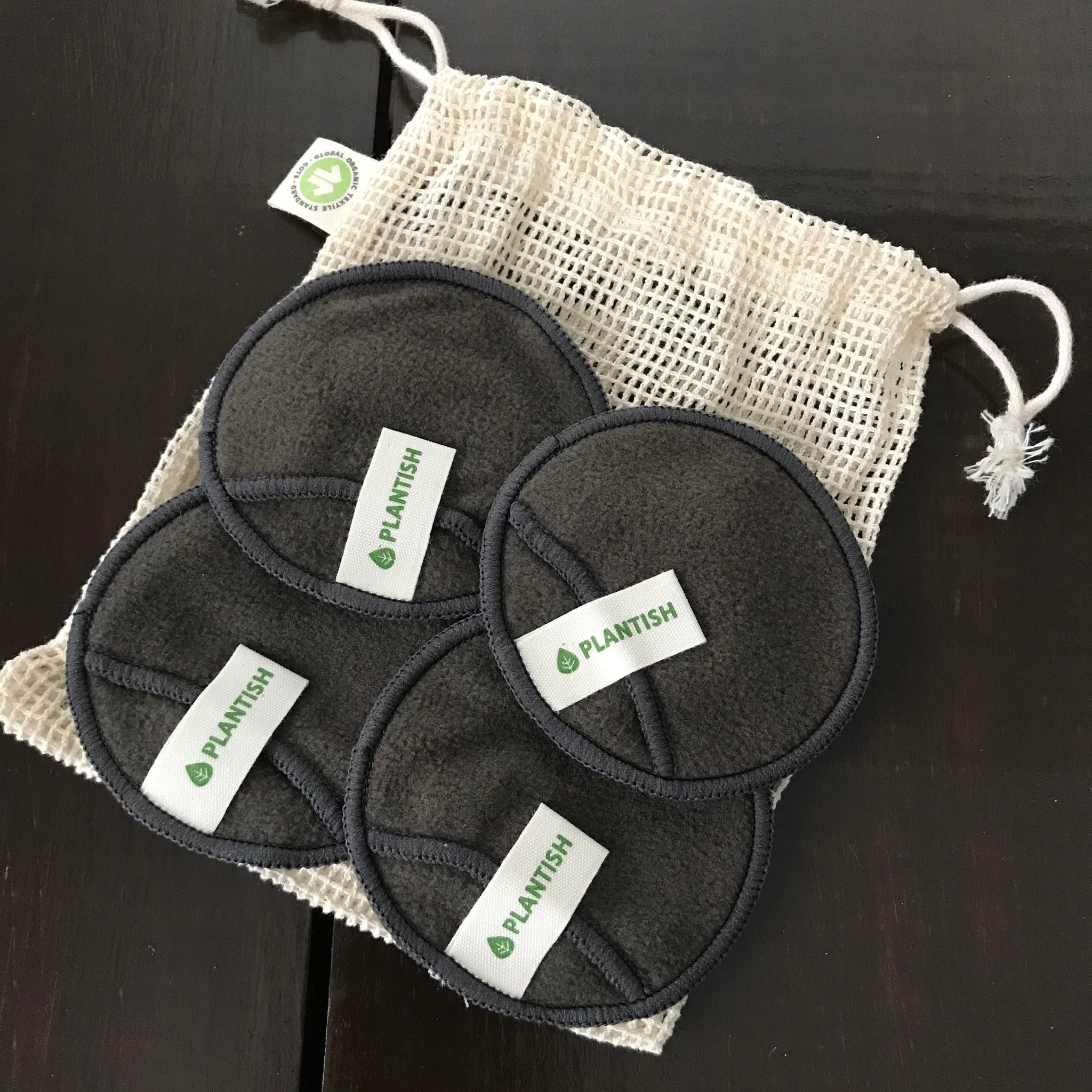 Set of four Plantish bamboo charcoal reusable make up remover pads in an mesh organic cotton bag for washing
