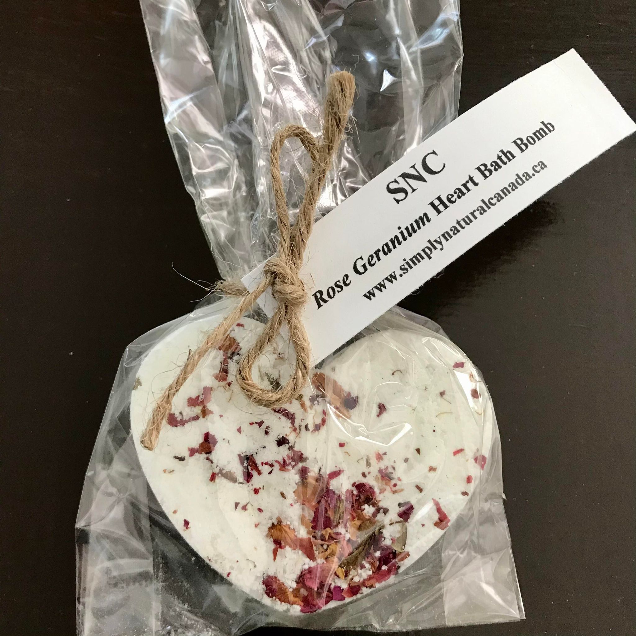 rose geranium full bath sized heart bath bomb with rose petals packaged in a clear compostable bag made in canada by simply natural canada