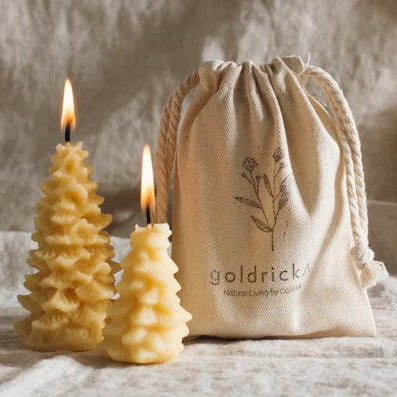 Two Christmas tree candles in an printed organic cotton gift bag handpoured with pure local beeswax in Ireland in the Goldrick Natural Living family workshop